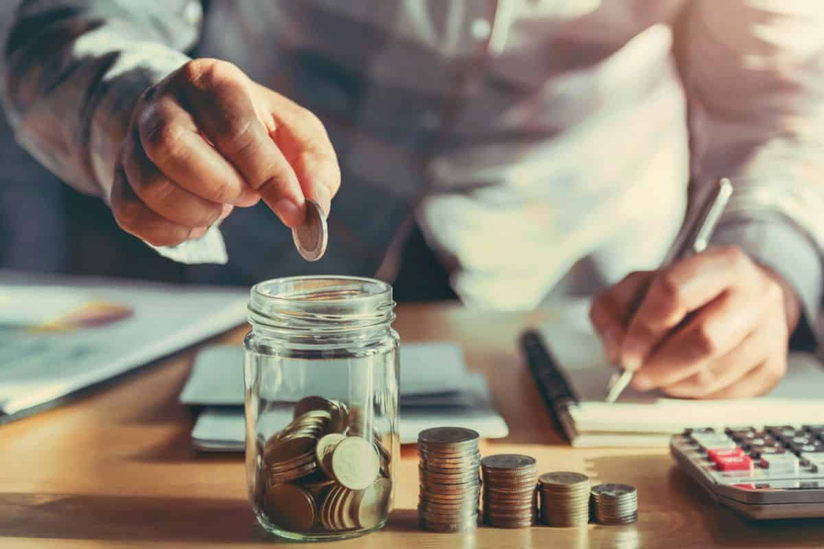 businesswoman-holding-coins-putting-glass