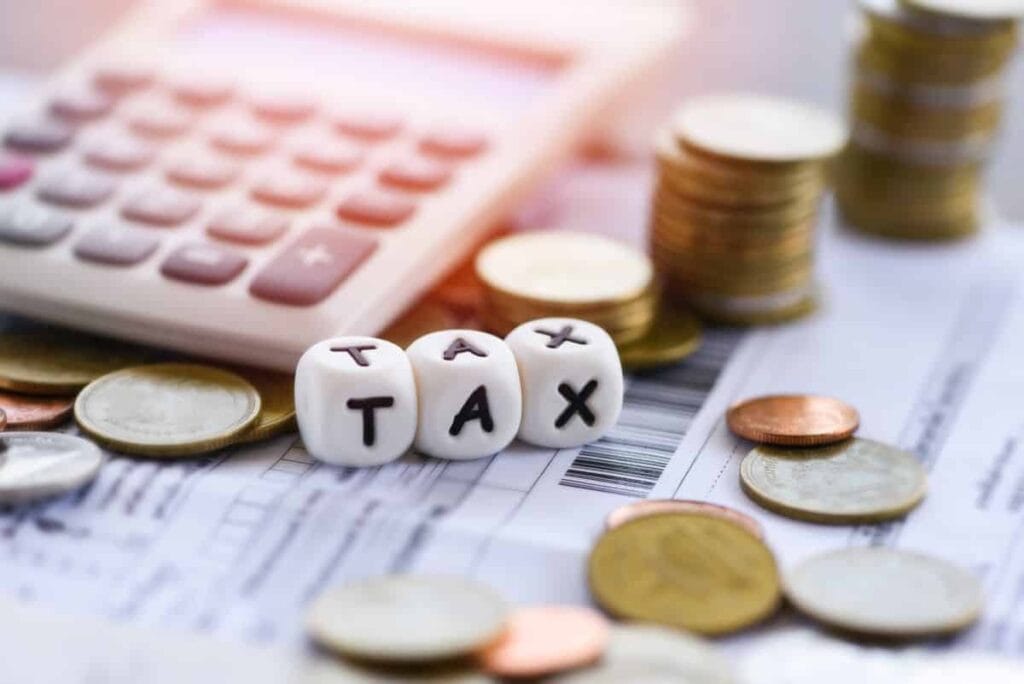 tax-words-calculator-stacked-coins-invoice-bill-paper-time-tax-filling