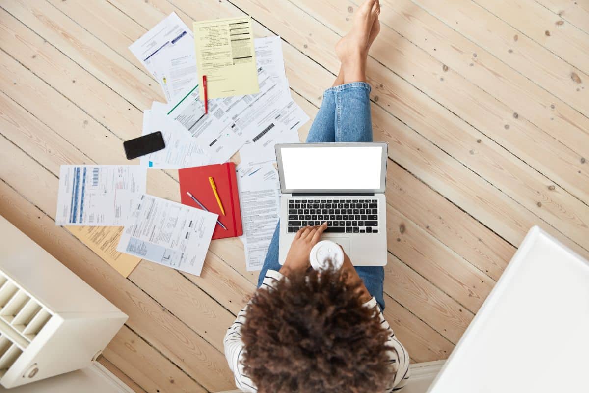 top view darrk skinned female deals with bills taxes